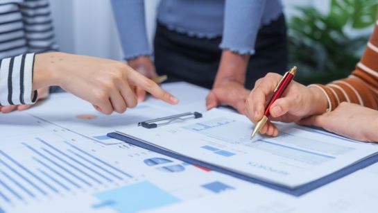 Colleagues Looking At Charts And Tables